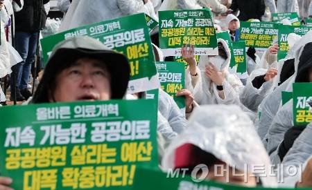 전국보건의료산업노동조합 조합원들이 지난해 11월 서울 영등포구 여의도 국회 앞에서 열린 공공병원 기능 회복?역량 강화 촉구 결의대회에서 손피켓을 들고 구호를 외치고 있다./사진=(서울=뉴스1) 김성진 기자