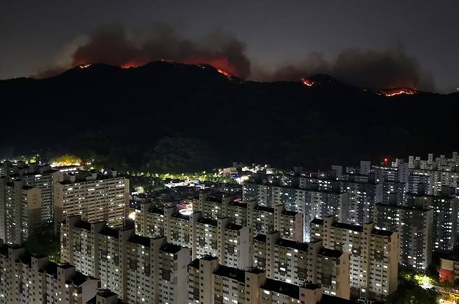 28일 밤 대구 북구 노곡동과 조야동 인근 산을 따라 불이 주택가 방향으로 확산하고 있다./뉴시스