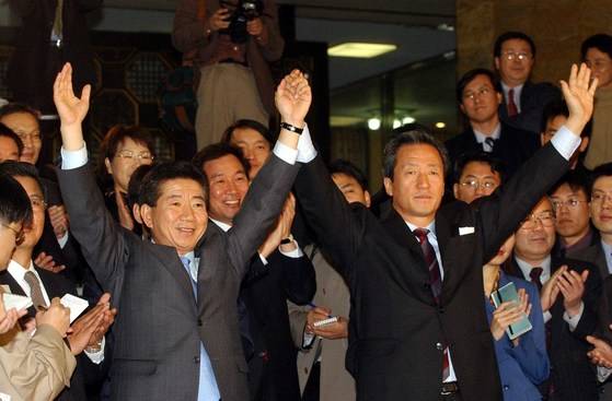 2002년 대선을 앞둔 당시 단일화에 성공한 노무현 새천년민주당 후보와 정몽준 국민통합21 후보가 손을 잡고 걸어나오고 있다. 장문기 기자