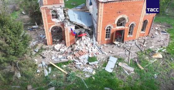 North Korean soldiers are seen planting a red Soviet flag beside a Russian one in a video released by Russia's state-run Tass News Agency [SCREEN CAPTURE]
