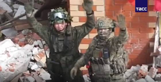A North Korean soldier is seen waving at the camera with a Russian soldier in a video released by Russia's state-run Tass News Agency [SCREEN CAPTURE]