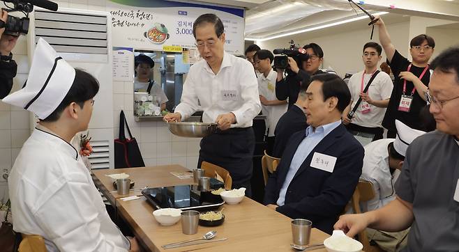 한덕수 국무총리가 2024년 7월 7일 서울 종로구 청년밥상문간 슬로우점을 방문해 경계선지능 청년과 보호자들을 격려하고 식사를 서빙하고 있다. /뉴스1