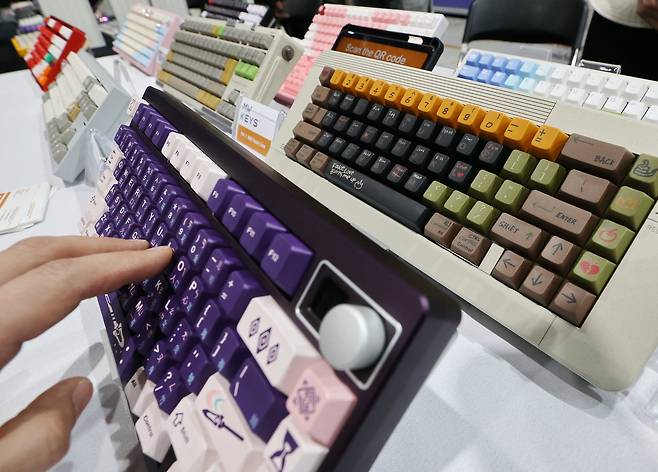 A hand is seen typing on a mechanical keyboard on display at the Seoul Mechanical Keyboard Expo 2025 on March 23. [YONHAP]