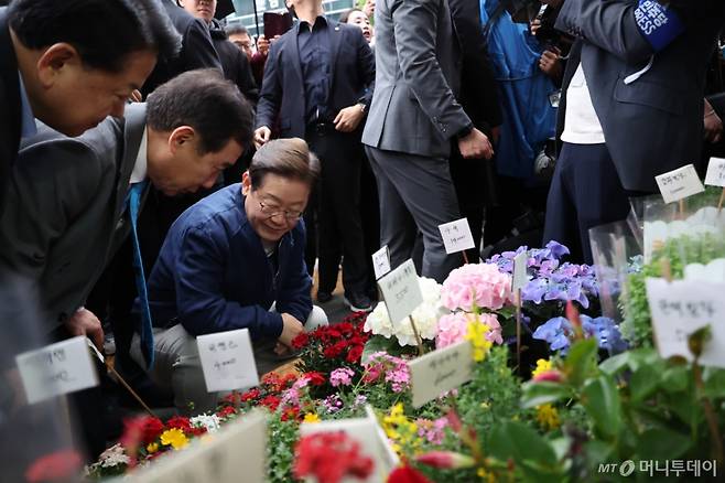 [포천=뉴시스] 조성우 기자 = 이재명 더불어민주당 대선후보가 1일 오후 경기 포천시 신읍사거리 인근서 골목골목 경청투어를 열고 꽃집을 방문해 둘러보고 있다. 2025.05.01. xconfind@newsis.com /사진=조성우