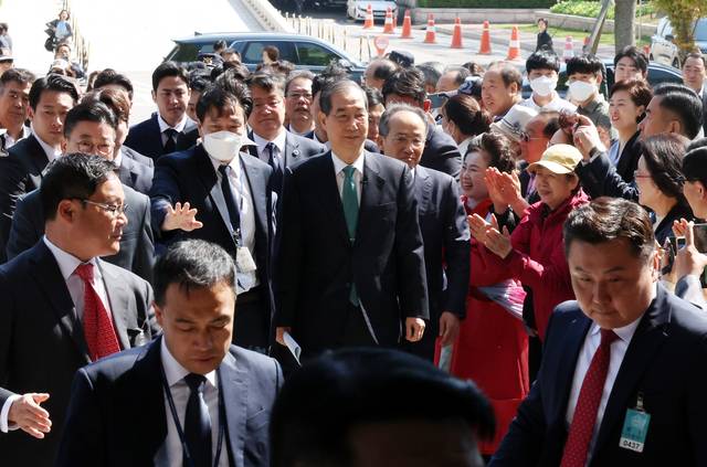 지지자 박수 받으며 입장 한덕수(가운데) 전 국무총리가 2일 오전 6·3 대통령 선거 출마를 선언하기 위해 국회 소통관에 들어서고 있다.  뉴시스