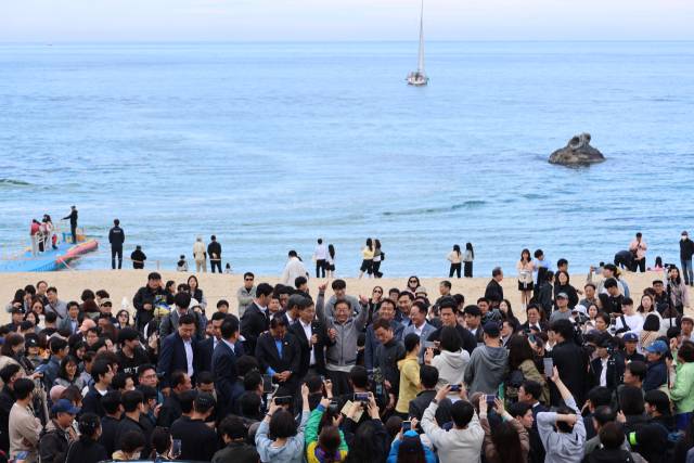 이재명 더불어민주당 대선 후보가 '골목골목 경청투어' 사흘째인 3일 강원도 동해안 지역의 민심을 공략하기 위해 강릉 안목해변을 찾아 이광재 전 강원지사 등과 함께 도민, 관광객들에게 지지를 호소하고 있다. 연합뉴스