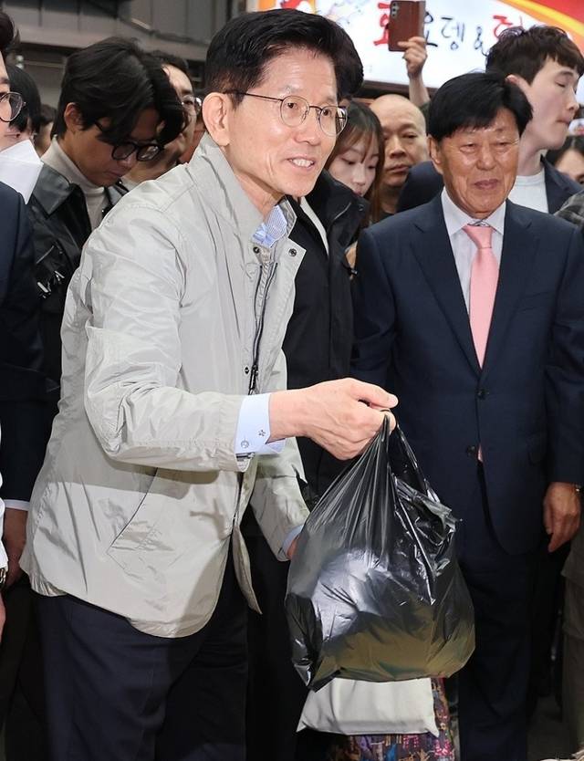 김문수 국민의힘 대선 후보가 6일 포항 죽도시장을 방문해 생선을 구입하며 상인과 대화하고 있다.