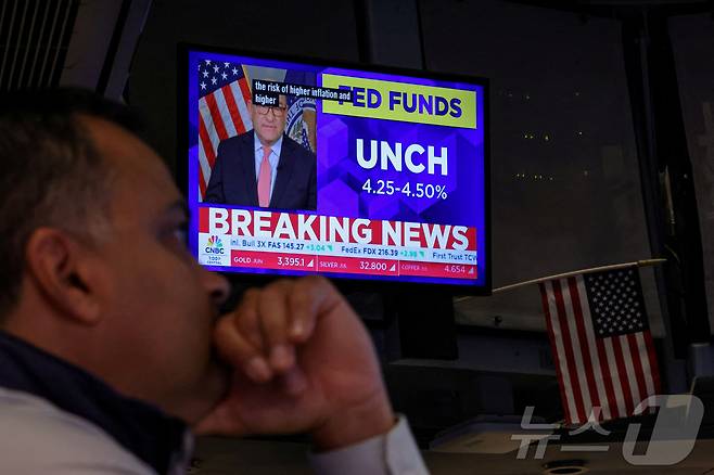 뉴욕증권거래소(NYSE)에서 TV 스크린을 통해 금리동결 결정뉴스가 나오는 가운데 트레이더들이 일하고 있다. 2025. 5.7 ⓒ 로이터=뉴스1