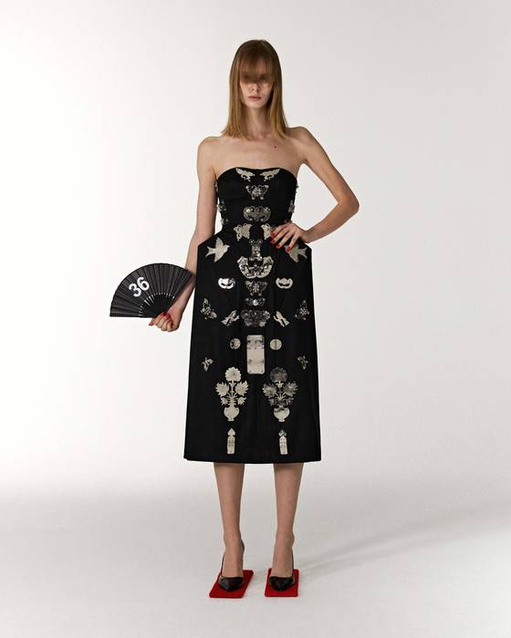 A look from Leje's 2025 F/W collection features artisanal metal fittings and handles for traditional Korean furniture on a structured dress. [LEJE]