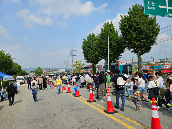 지난 11일 열린 오산공군기지 에어쇼를 관람한 시민들이 귀가하기 위해  미군부대 모린게이트에서 셔틀버스 정류장까지 걸어가고 있다. 시민들은 귀갓길 셔틀버스 탑승에 2시간 정도를 기다려야 했고, 송탄역과 서정리역으로 걸어가야 하는 경우도 많아 큰 불편을 겪었다. /독자 제공