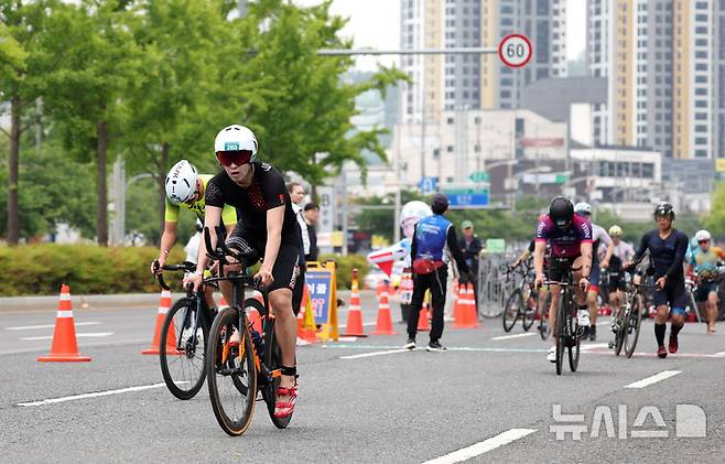 [대구=뉴시스] 이무열 기자 = 11일 대구 수성구 수성못과 신천동로에서 열린 ‘제21회 대구광역시장배 전국철인3종대회’에 출전한 참가자들이 힘차게 사이클 페달을 밟고 있다. 2025.05.11. lmy@newsis.com