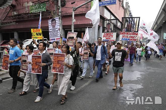 [마닐라=AP/뉴시스] 지난 3월 17일(현지 시간) 필리핀 마닐라에서 활동가들이 로드리고 두테르테 전 필리핀 대통령과 로널드 '바토' 델라 로사 상원의원의 사진을 들고 이들의 유죄 판결을 촉구하며 말라카냥궁으로 행진하고 있다. 이들은 두테르테 전 대통령의 국제형사재판소(ICC) 체포 이후 ICC 재가입을 촉구했다. 필리핀은 2019년 ICC에서 탈퇴했다. 2025.05.14.