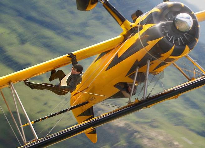 영화 ‘미션 임파서블: 파이널 레코닝’에서 톰 크루즈가 악당을 따라잡으려 항공기에 매달려 있다. ‘파이널 레코닝’은 실시간예매율 1위(68%, 15일 오후 11시 현재)로 2위인 ‘야당’(4%)을 크게 따돌리고 있다./롯데엔터테인먼트