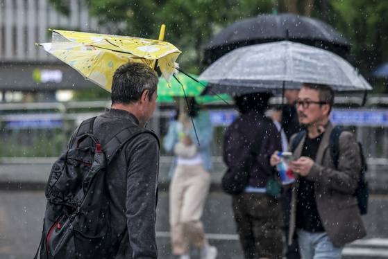 16일 서울 종로구 광화문네거리에서 우산을 쓴 시민들이 이동하고 있다. 뉴시스