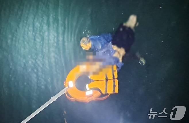 지난 17일 밤 제주 서귀포시 법환포구 앞바다에서 이대웅 경사가 물에 빠진 시민을 구조하고 있다.(서귀포경찰서 제공. 재판매 및 DB 금지)