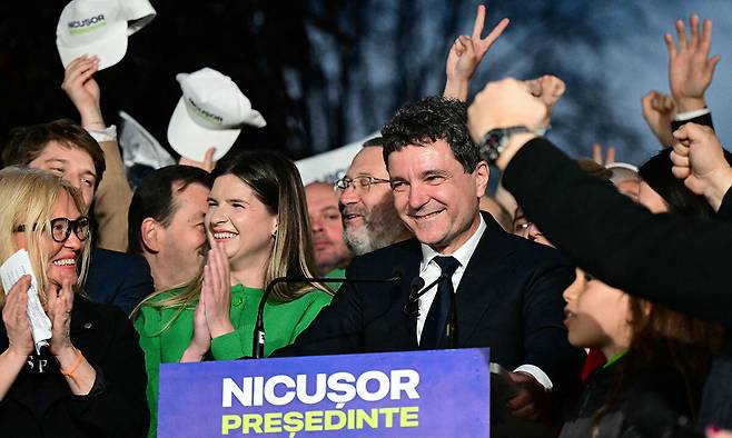 루마니아의 니쿠쇼르 단 부쿠레슈티 시장(가운데)이 18일(현지시간) 치러진 대통령 선거 결선 투표에서 극적 승리를 거둔 뒤 지지자들의 환호를 받으며 연설을 하고 있다. 부쿠레슈티=AFP연합뉴스