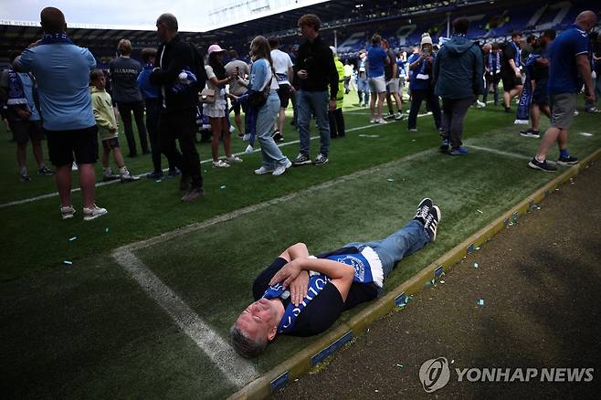 에버턴의 마지막 홈경기가 치러진 구디슨 파크 잔디에 누운 팬 [EPA=연합뉴스]