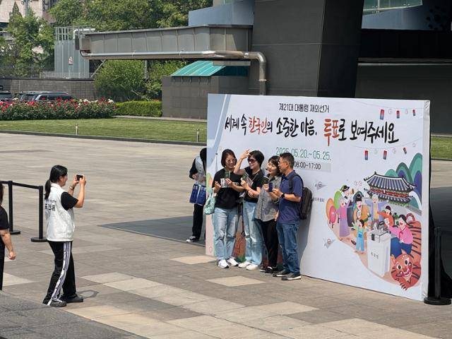 제21대 대통령 재외국민선거가 시작된 20일 중국에 거주하는 교민들이 투표소가 마련된 베이징 주중한국대사관에서 투표 인증샷을 찍고 있다. 베이징=이혜미 특파원