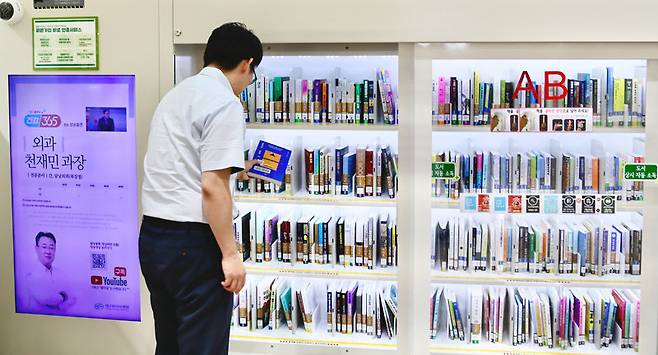 19일 대구 동구 대구파티마병원 동관 1층 스마트도서관에서 병원 이용객이 책을 빌리고 있다. 대구파티마병원 제공