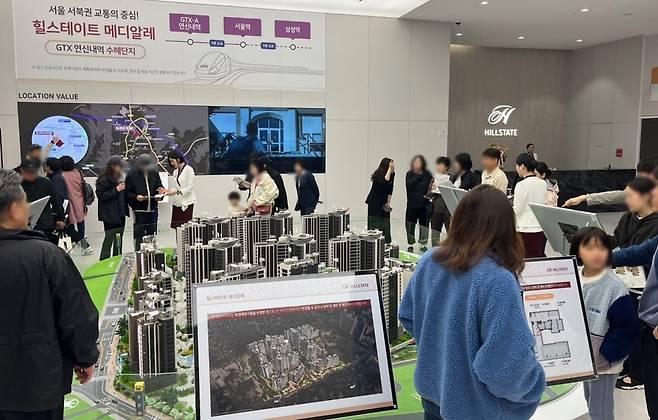 힐스테이트 메디알레 모델하우스에서 예비 청약자들이 아파트 모형을 보고 있다. 사진=현대건설
