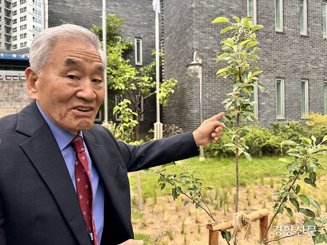 이재오 민주화운동기념사업회 이사장이 지난 20일 서울 용산구 민주화운동기념관에 있는 ‘민주 과수원’에서 사과나무를 가리키며 말하고 있다. 주영재 기자