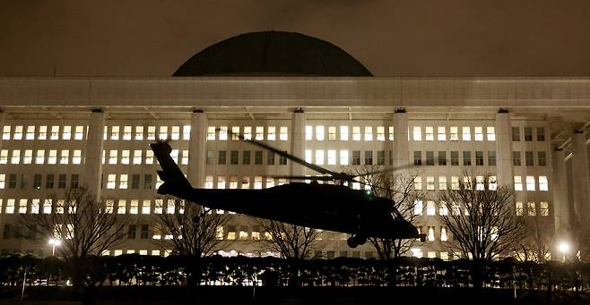 As then-President Yoon Suk Yeol declared martial law in an emergency national address, a military helicopter carrying troops lands on the National Assembly field in Yeouido, Seoul, in the early hours of Dec. 4, 2024. [JEON MIN-KYU]