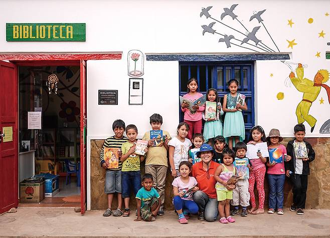 2018년 코이카가 제공한 도서관 앞에서 기념 촬영을 하는 해외봉사단원과 볼리비아 아이들. / 사진 코이카