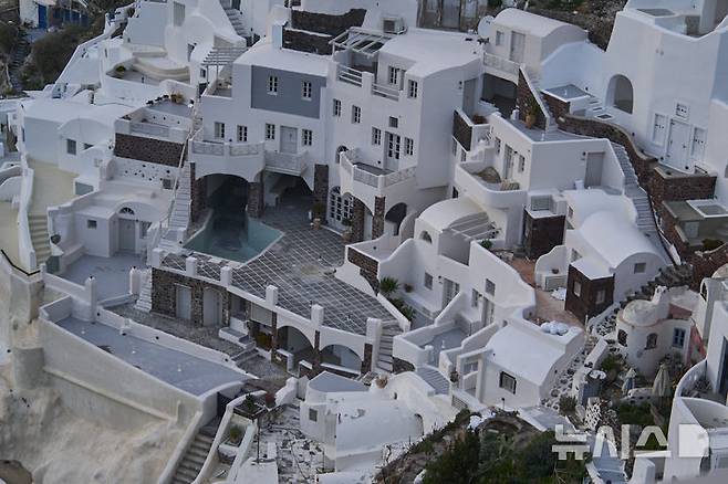[산토리니=AP/뉴시스]2월 4일 그리스 산토리니 섬 오이아 마을의 한 건물 수영장이 텅 비어 있다. 최근 산토리니섬과 주변 섬에서 200회 이상의 지진이 발생하면서 주민과 관광객들이 공포 속에 섬을 떠났지만 각종 재해에도 그리스의 관광부문은 계속 수익이 증가하고 있다고 그리스국립은행이 발표했다. 2025. 05.26.