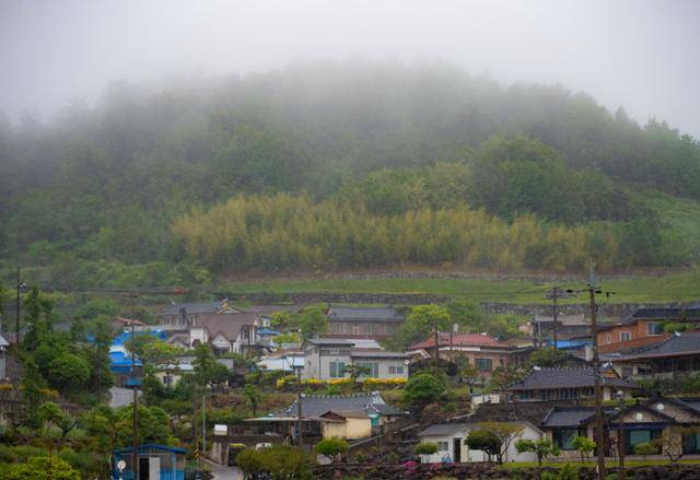 우도의 마을 뒤로 보이는 봉들산이 해무에 잠겨 있다.