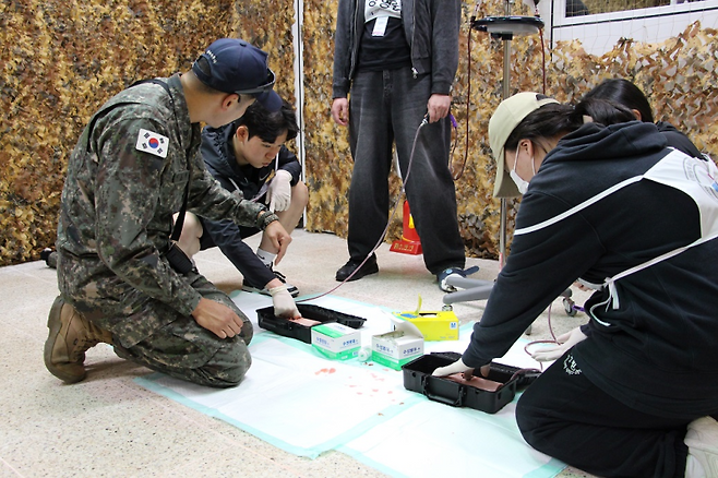 최근 국군의무학교 의무종합훈련센터에서 진행한 ‘전투부상자 처치 체험형 교육과정’에 대구보건대 재학생들이 전투 상황을 가정한 시뮬레이션 실습에 참여하고 있다. 대구보건대 제공