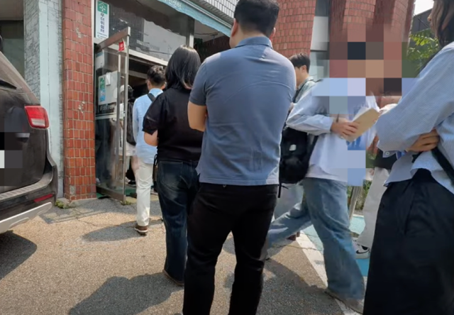 21대 대선 사전투표일 첫날인 29일 서울 서대문구 구 신촌동 주민센터 사전투표소 입구에서 한 시민이 투표용지와 회송용 봉투를 들고 건물 입구 밖으로 이어진 줄 맨끝으로 향하고 있다. 유튜브채널 '애국청년 박준영' 캡처