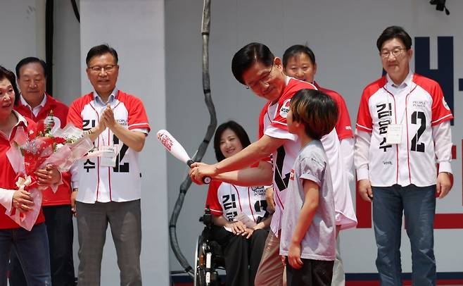 김문수 국민의힘 대선 후보가 31일 강원 속초 관광수산시장에서 유세를 하기 전 선물받은 '역전홈런'이라고 쓰여진 야구 배트를 휘두르는 포즈를 취하고 있다. 뉴시스