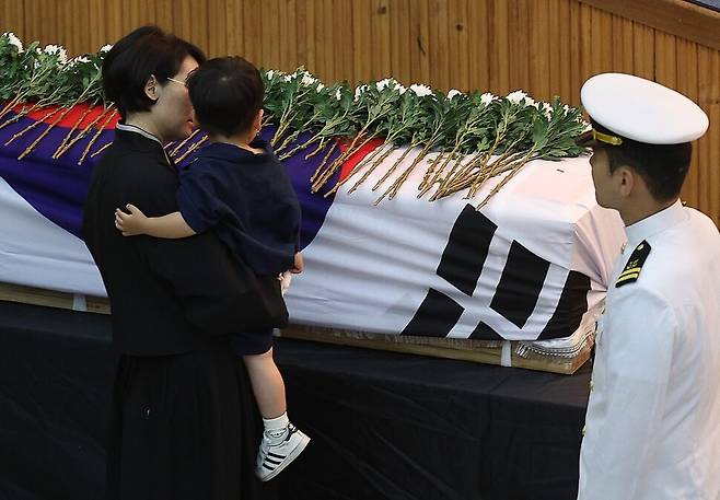 1일 경북 포항시 해군 항공사령부 강당에서 엄수된 ‘해군 P-3CK 917호기 순직자 영결식\'에서 순직 해군 장병의 어린 아들이 헌화하며 마지막 배웅을 하고 있다. 연합뉴스