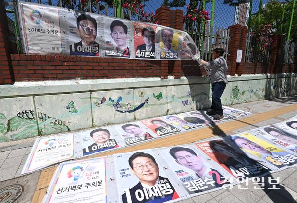 제21대 대통령선거 다음 날인 4일 오후 수원시 영통구 동수원중학교 담장에서 벽보 철거업체 관계자가 선거 벽보를 철거하고 있다. 2025.6.4 /최은성기자 ces7198@kyeongin.com