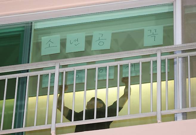 이재명 대통령의 자택인 인천 계양구 아파트에서 한 주민이 이 후보 당선을 축하하며 ‘소년공 꼭 성공하세요’라는 문구를 창문에 붙이고 있다. 연합뉴스