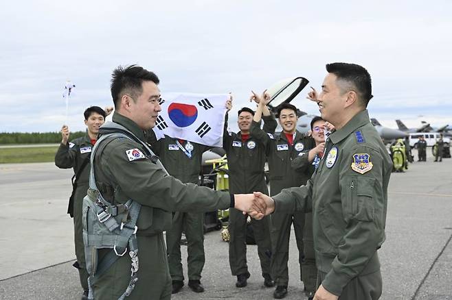 2025 레드플래그 알래스카 훈련단장 신용주 대령이 한국에서 전투기를 이끌고 미국 알래스카주 아일슨 기지에 무사히 착륙한 KF-16 페리 조종사 김민기 소령을 반갑게 맞이하고 있다. 공군 제공