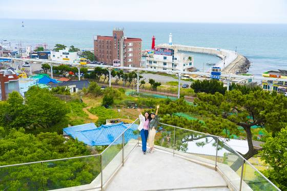 대만 모녀 여행객의 모습. 뒤쪽으로 스카이캡슐과 청사포 명물 쌍둥이 등대가 보인다.