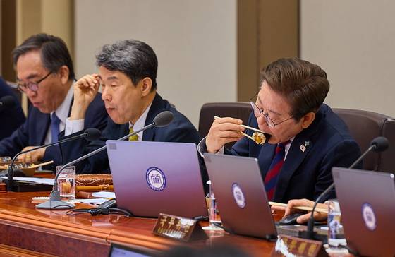이재명 대통령이 5일 용산 대통령실에서 주재한 첫 국무회의 도중 점심으로 김밥을 먹고 있다. 이날 회의에는 이주호 국무총리 직무대행 겸 부총리(가운데)를 비롯해 조태열 외교부 장관(왼쪽), 유상임 과기정통부 장관 등 윤석열 정부 때 임명된 국무위원들이 다수 참석했다. [사진 대통령실]