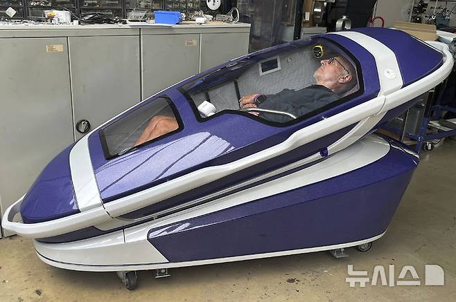Philip Nitschke is seen inside a 'suicide pod' known as 'The Sarco' in Rotterdam, The Netherlands, July 8, 2024. (AP Photo/Ahmad Seir)