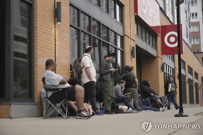 Nintendo-Switch-2 People line up outside a Target store for the new Nintendo Switch 2 video game consoles on Thursday, June 5, 2025 in Chicago. (AP Photo/Kiichiro Sato)