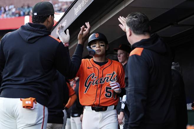 이정후가 지난 7일(한국시각) 애틀랜타전에서 1회말 우전안타로 나간 뒤 오미닉 스미스의 희생플라이 때 홈으로 들어와 동료들의 환영을 받고 있다. AP연합뉴스