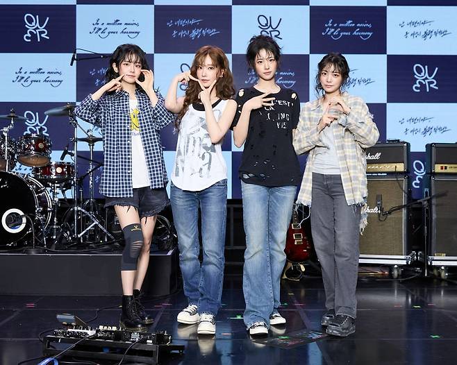 From left: QWER's Chodan, Magenta, Hina and Siyeon pose for a photo at a press conference in Mapo-gu, Seoul, Monday. (Content X)