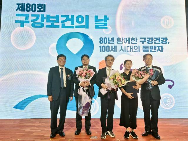 부산대치과병원 김현철(가운데) 병원장이 지난 9일 서울 명동 포스트타워 대회의실에서 열린 ‘제80회 구강보건의 날’ 기념식에서 보건복지부장관 표창을 수상했다. 부산대학교치과병원이 위탁 운영 중인 경남권역장애인구강진료센터의 우미나(오른쪽에서 두 번째) 치과의사도 같은 날 보건복지부장관 표창을 수상했다. 부산대치과병원 제공
