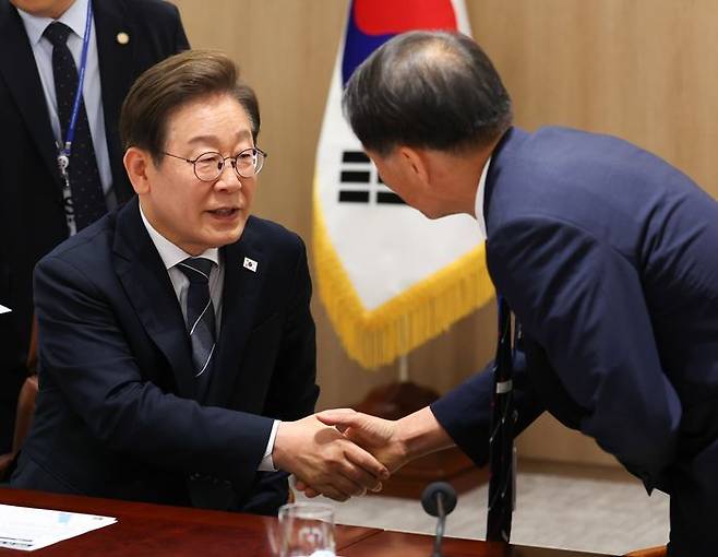 이재명 대통령이 13일 용산 대통령실에서 이스라엘의 이란 공습관련 경제안보 긴급 점검회의에 참석한 송기호 국정상황실장과 악수하고 있다. ⓒ연합뉴스