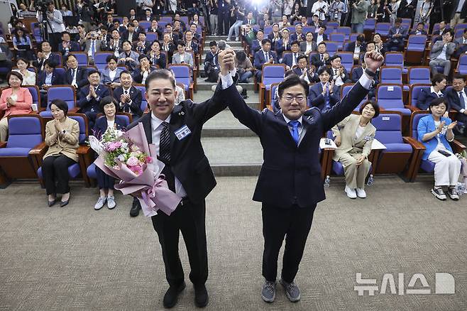 [서울=뉴시스] 권창회 기자 = 김병기 신임 원내대표가 13일 서울 여의도 국회에서 열린 제2기 원내대표 선출 의원총회에서 당선 된 뒤 박찬대 전 원내대표와 손을 맞잡고 있다. (공동취재) 2025.06.13. photo@newsis.com