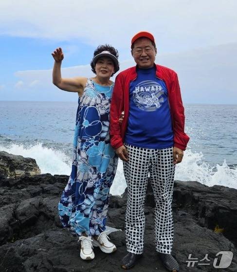 부인과 함께 하와이 빅아일랜드에 머물고 있는 홍준표 전 대구시장. 빨간색(국민의힘 상징색) 겉옷 속에 파란색(더불어민주당 상징색) 옷을 입어  이당 저당도 보기 싫다는 메시지가 아닌가라는 해석도 낳았다. (SNS 갈무리) ⓒ 뉴스1