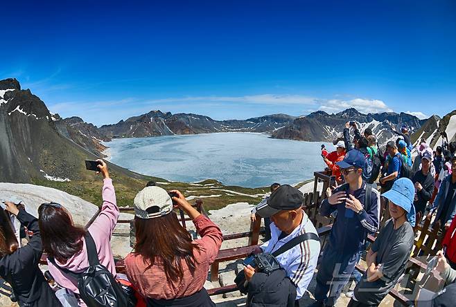 지난 12일(현지시간) 중국 지린성 연변 조선족 자치주 백두산 서파에서 관광객들이 천지를 살펴보고 있다. (공동취재) 2025.6.15/뉴스1 ⓒ News1 황기선 기자