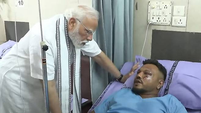 에어인디아 추락기 생존자 비슈와시 쿠마르 라메시를 만나는 모디 총리=AFP 연합뉴스