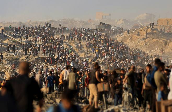 16일 가자지구 북부 바이트라히야에서 주민들이 구호품을 받고 있다. 바이트라히야/로이터 연합뉴스