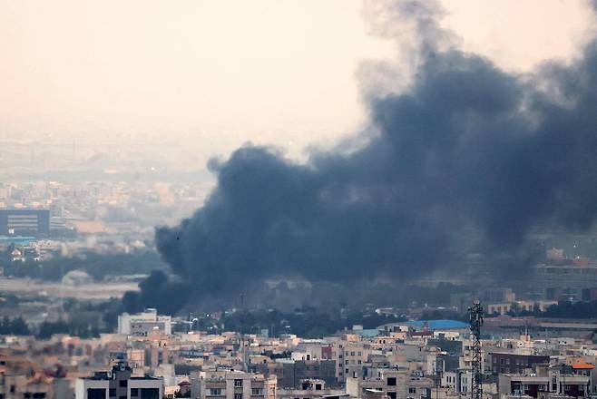 Smoke from an explosion in southwest Tehran billows on Monday. The Islamic Republic of Iran Broadcasting building was struck in an Israeli attack on June 16, cutting live coverage immediately.  (AFP)